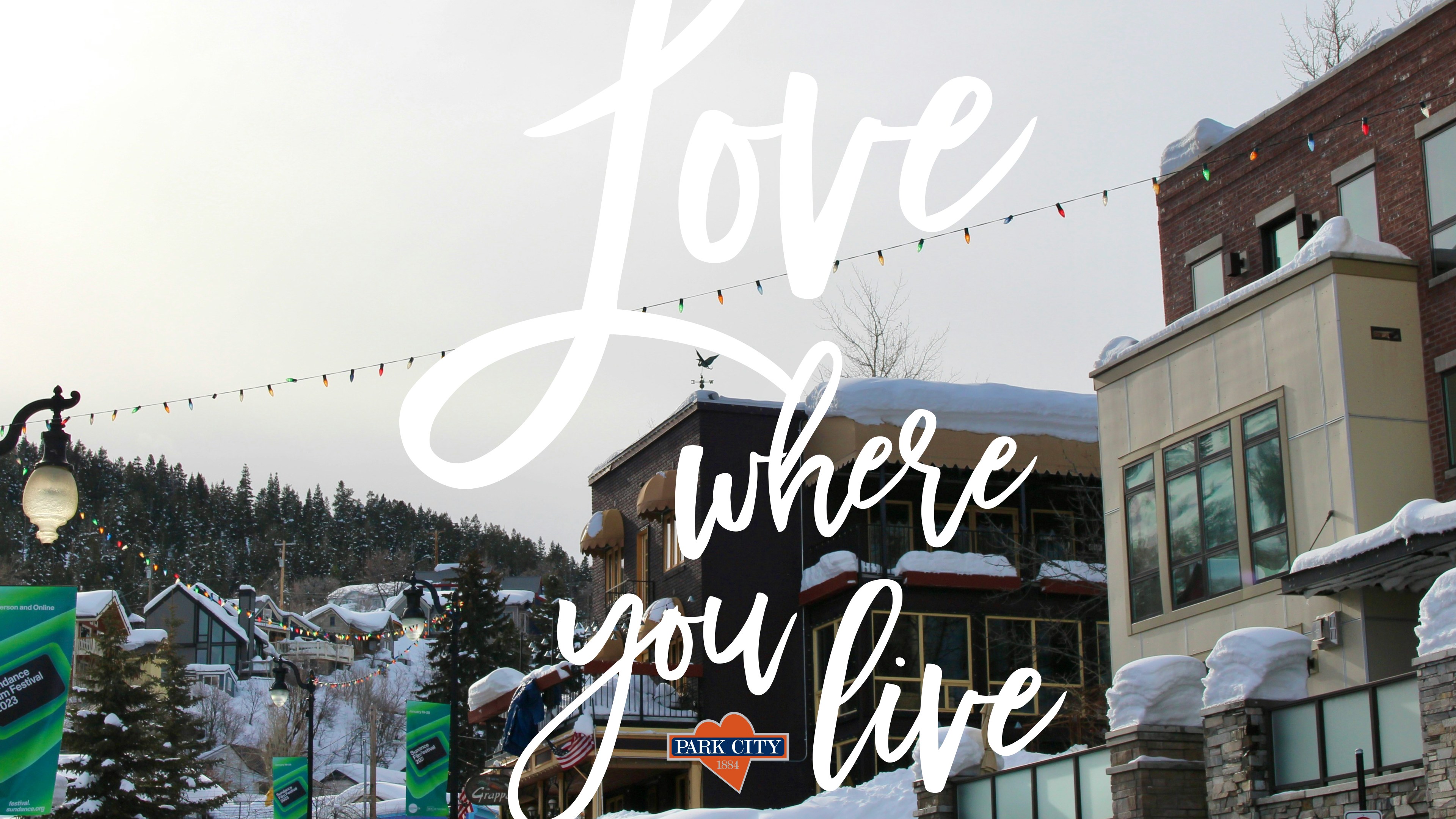 Love where you live treatment over a snowy Park City street, with the Park City mark and heart